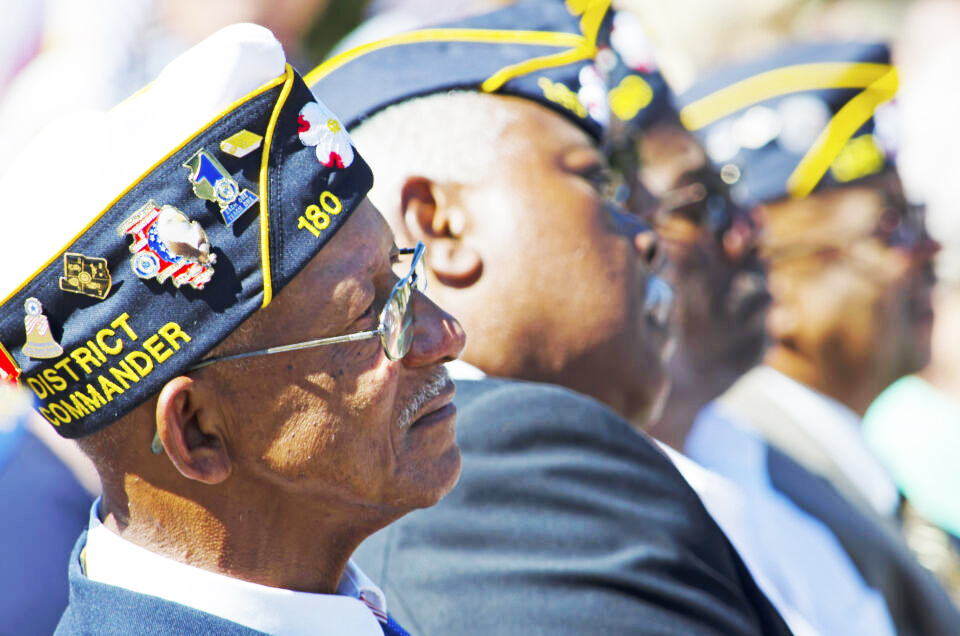 Belmont, North Carolina, USA - October 4, 2014: World War II Veterans give their attention to North Carolina Governor, Pat McCrory during a speech dedicating of a statue to honor the Veterans of World War II.